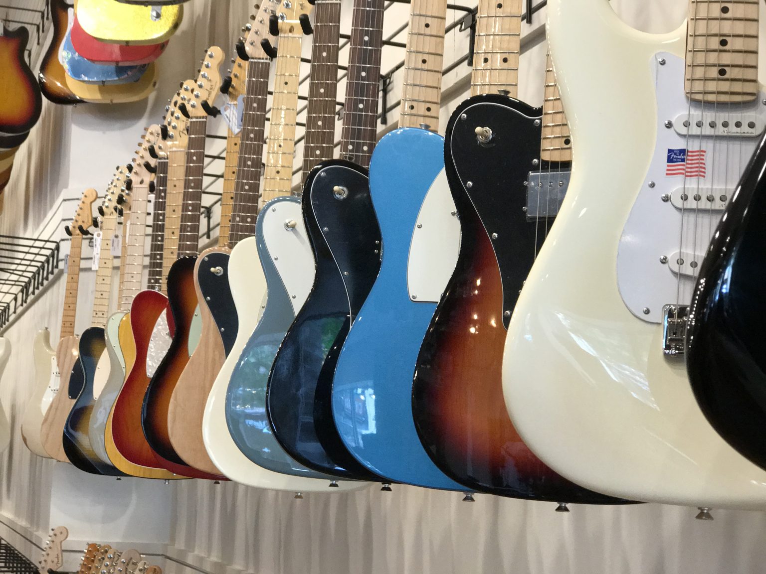 Row of colorful hanging guitars