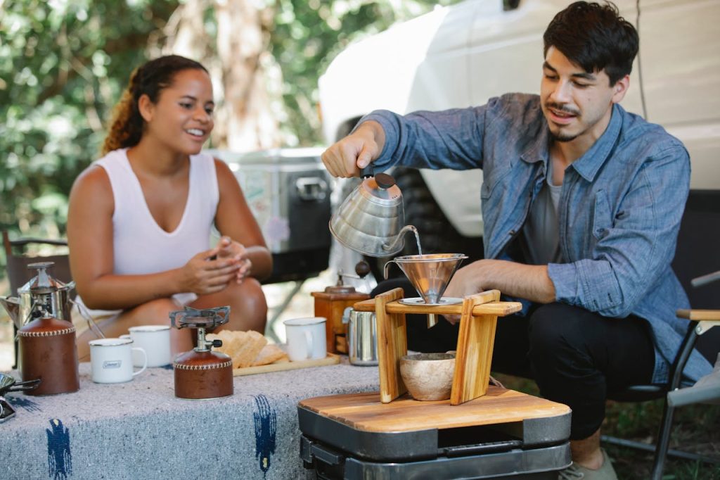 Cheerful diverse couple pouring hot water into pour over filter